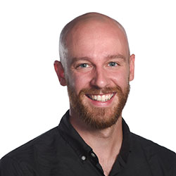 A college professor with a beard and a black shirt on a white background